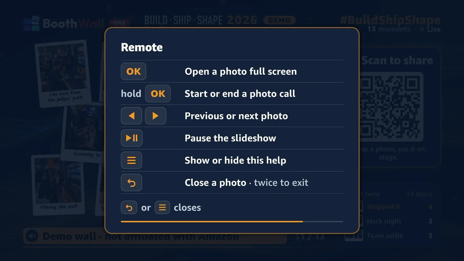 The remote help card over the wall: OK opens a photo, hold OK starts or ends a photo call, left and right step through photos, Play/Pause pauses, Menu shows or hides the help, Back closes a photo